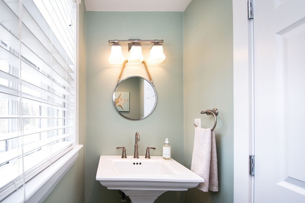 250 First Parish Road Scituate, MA 02066 - Photo 14 of 25 a bathroom with a sink and a mirror
