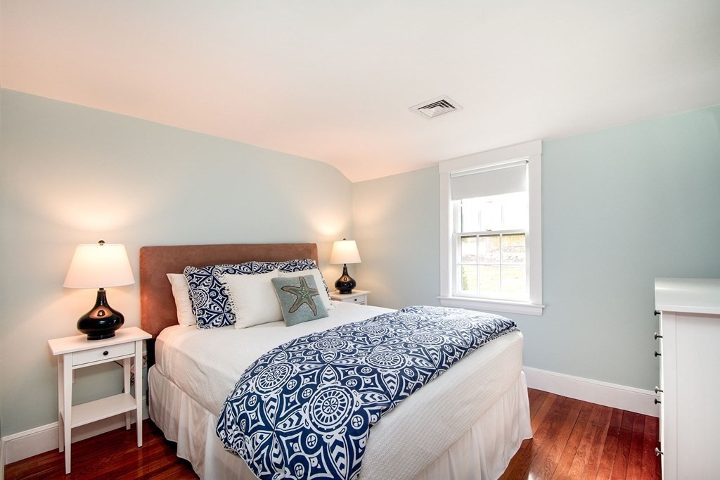 250 First Parish Road Scituate, MA 02066 - Photo 17 of 25 a bedroom with a bed and wooden floor