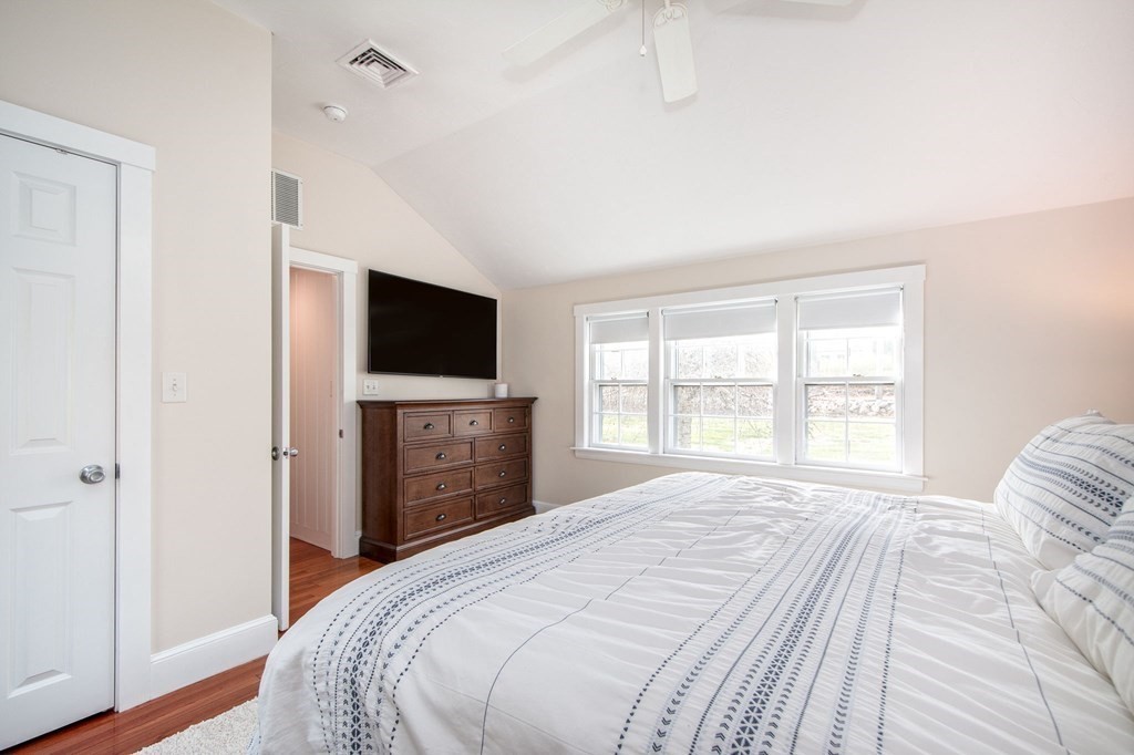 250 First Parish Road Scituate, MA 02066 - Photo 19 of 25 a bedroom with a bed and a flat screen tv
