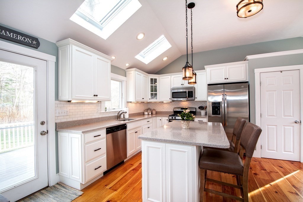 250 First Parish Road Scituate, MA 02066 - Photo 7 of 25 a kitchen with kitchen island a counter space a sink appliances and cabinets