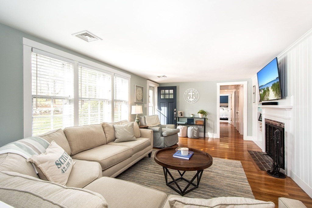 250 First Parish Road Scituate, MA 02066 - Photo 10 of 25 a living room with fireplace furniture and a flat screen tv