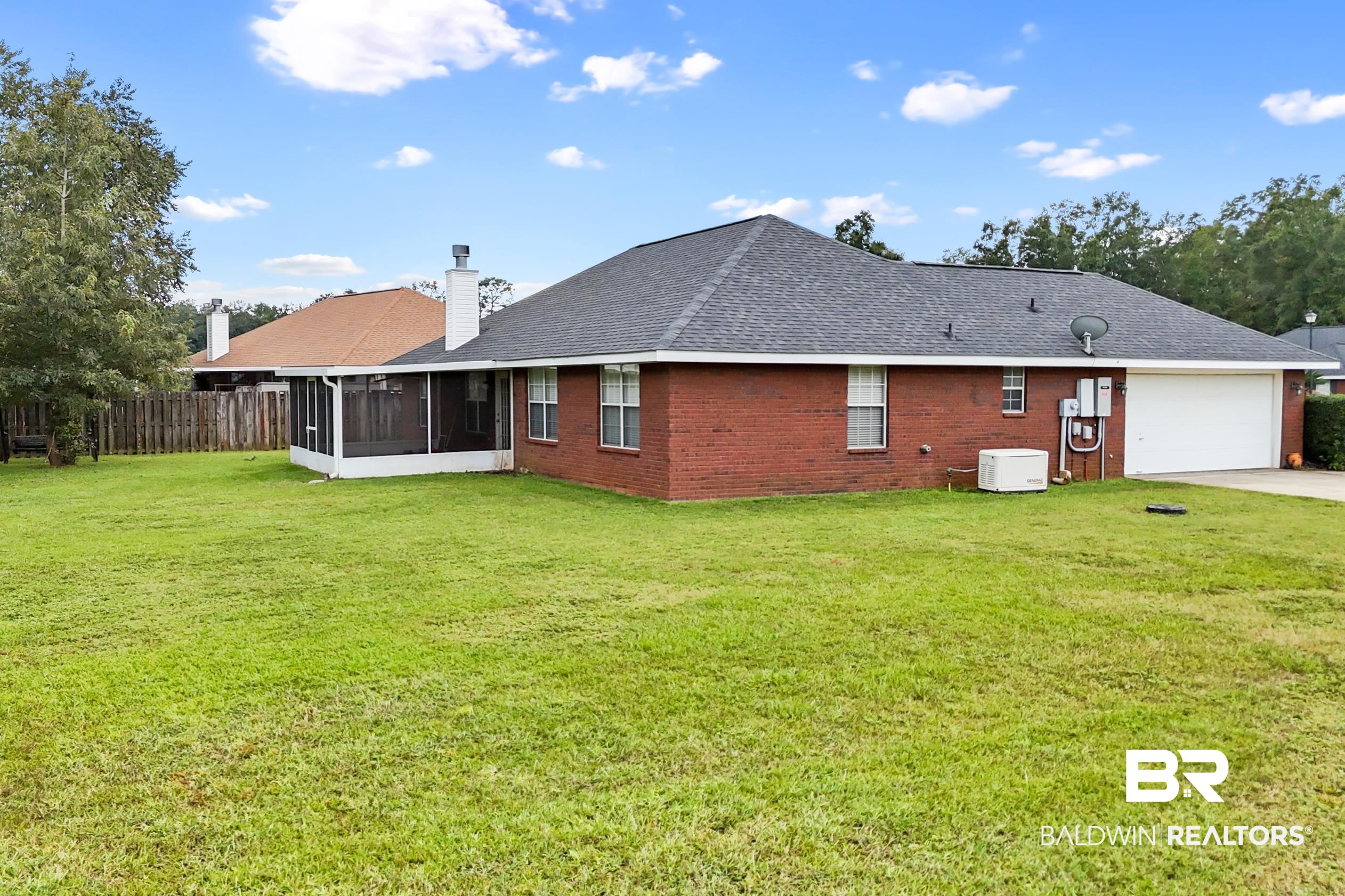 306 Monteith Oaks Drive Foley, AL 36535 - Photo 30 of 38 Rear view of house featuring a shingled roof, a sunroom, brick siding, a chimney, and driveway