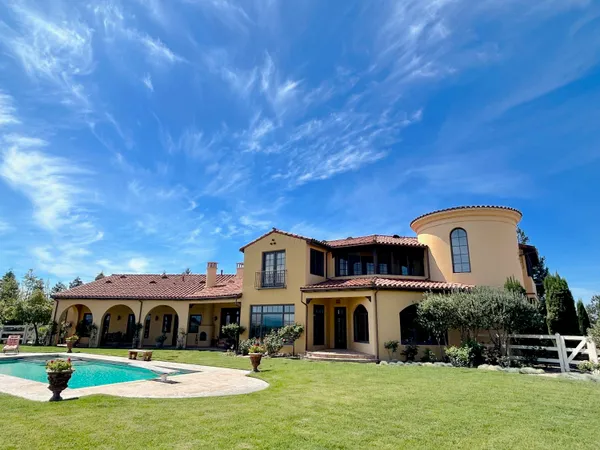 a front view of a house with a swimming pool