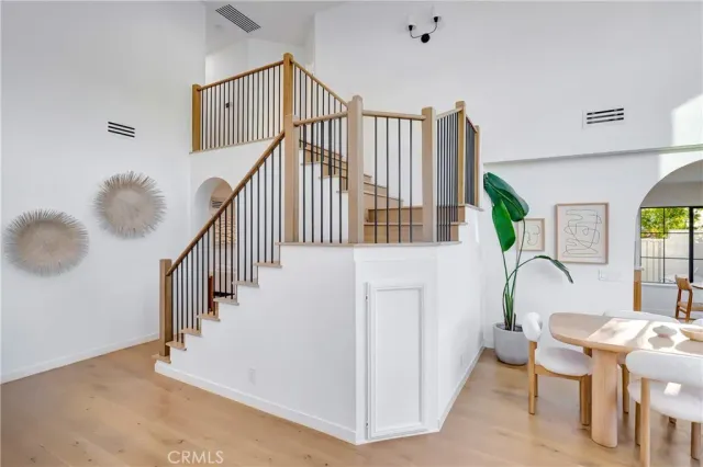 a kitchen with a table chairs stove and wooden floor