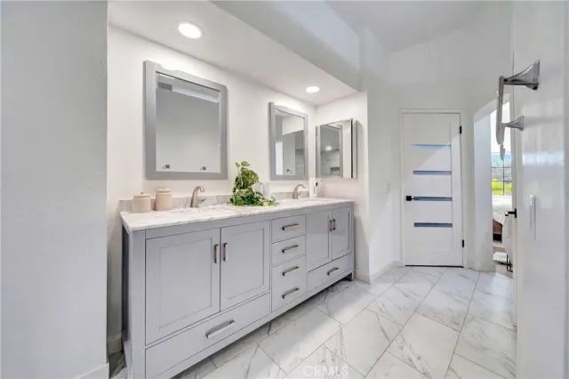 a bedroom with furniture and a large window