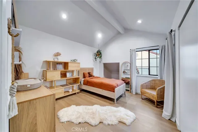 a spacious bedroom with a bed and a desk