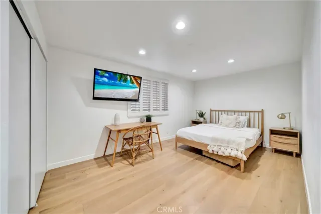 a bedroom with furniture and a flat screen tv