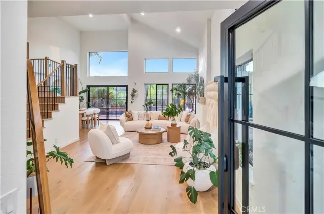 a living room with patio furniture and a large window