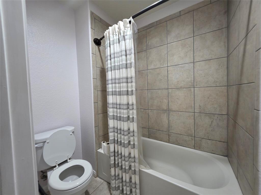 149 Ryan Street Anna, TX 75409 - Photo 24 of 38 a bathroom with a toilet and a shower