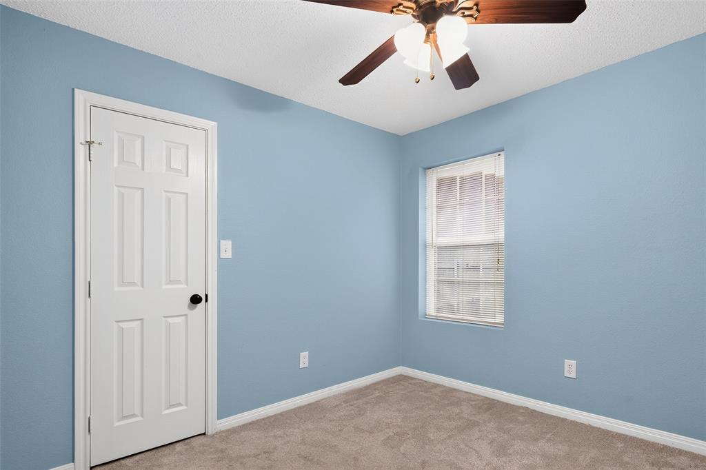 124 Topaz Circle Hewitt, TX 76643 - Photo 20 of 35 Carpeted room featuring a ceiling fan with light fixture, a window with blinds, and a paneled door