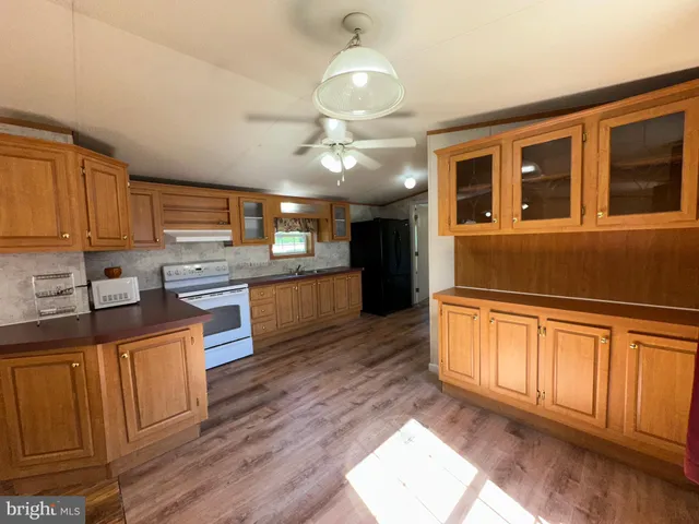 a kitchen with stainless steel appliances granite countertop a refrigerator a sink and dishwasher