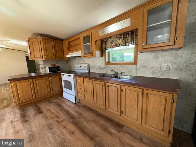 a kitchen with sink cabinets and window
