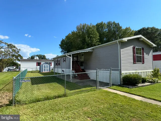 a view of backyard with deck and seating space