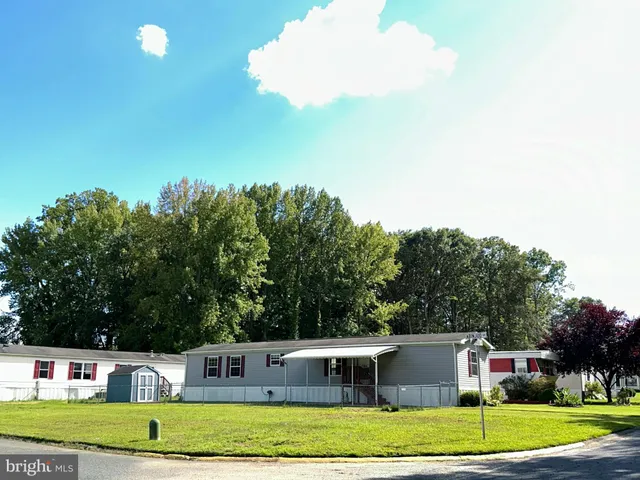 a view of swimming pool with a garden and plants