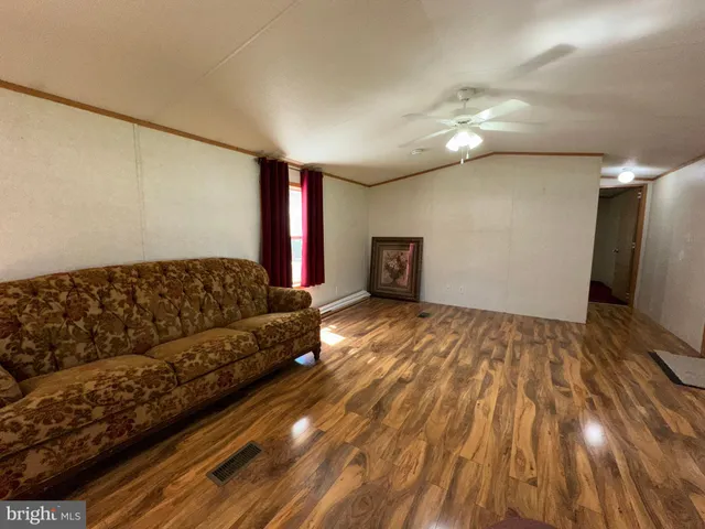 a spacious bedroom with a bed and a chandelier