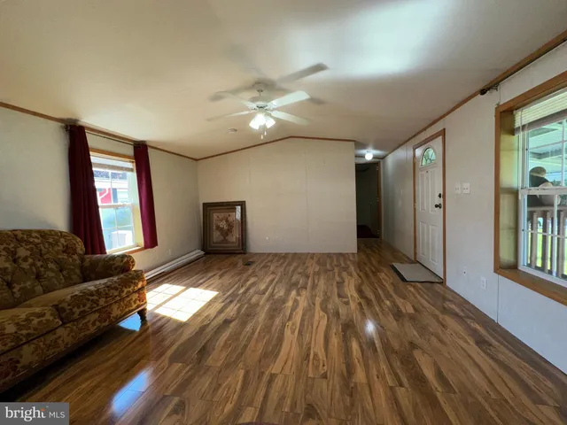 a view of livingroom with hardwood floor and a ceiling fan