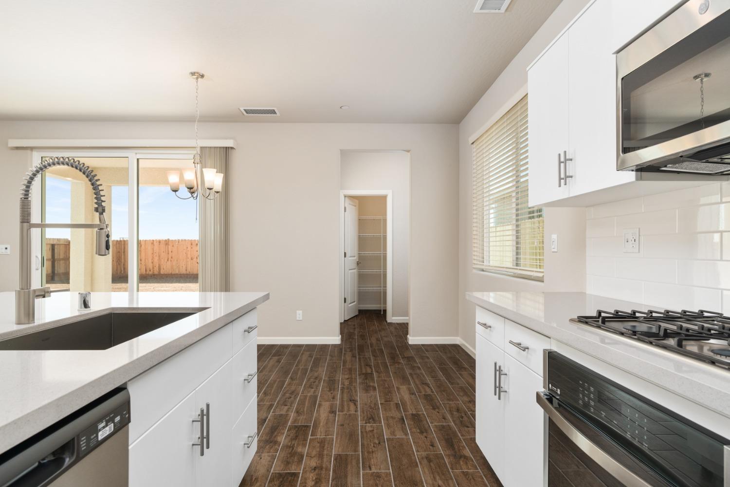 783 Traverse Drive Madera, CA 93636 - Photo 12 of 30 a kitchen with a sink and a stove top oven