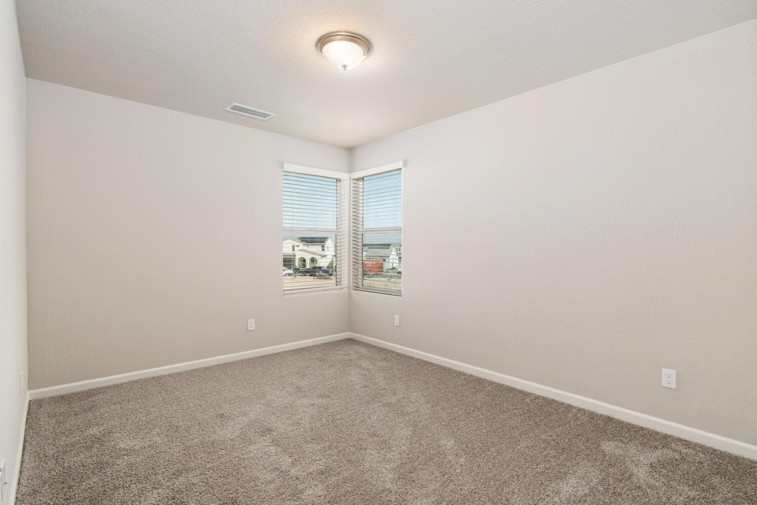 783 Traverse Drive Madera, CA 93636 - Photo 17 of 30 an empty room with a empty space and window