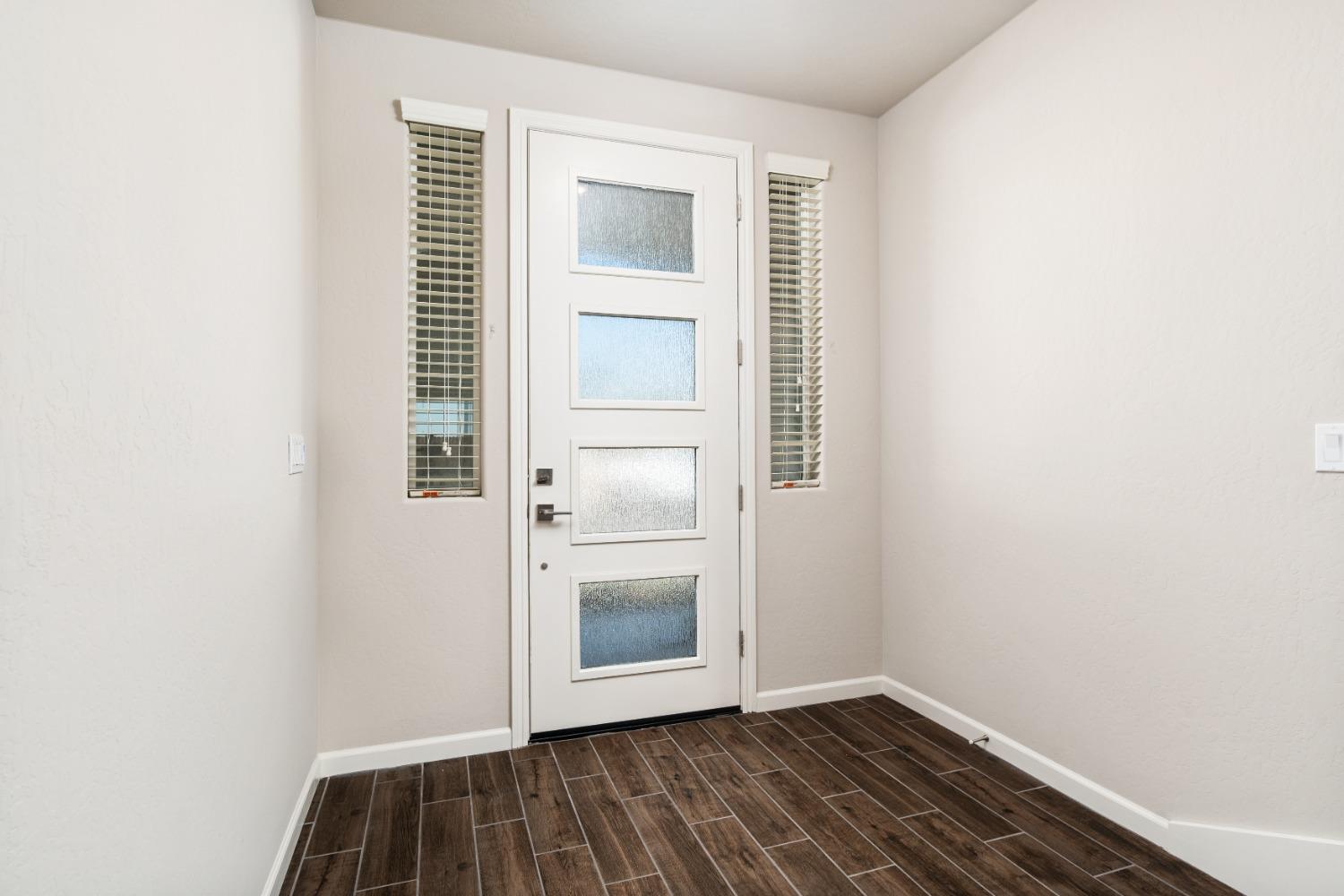 783 Traverse Drive Madera, CA 93636 - Photo 4 of 30 a view of an empty room with wooden floor and a window