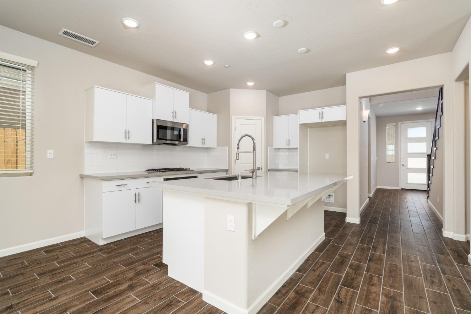 783 Traverse Drive Madera, CA 93636 - Photo 10 of 30 a kitchen with stainless steel appliances granite countertop a sink stove and microwave