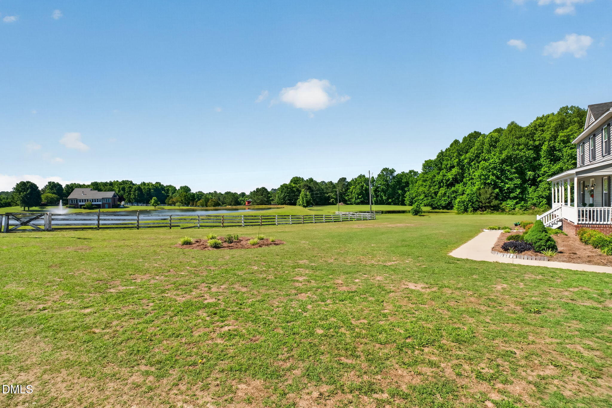 923 White Memorial Church Road Willow Spring, NC 27592 - Photo 7 of 46 a view of a lake and a yard