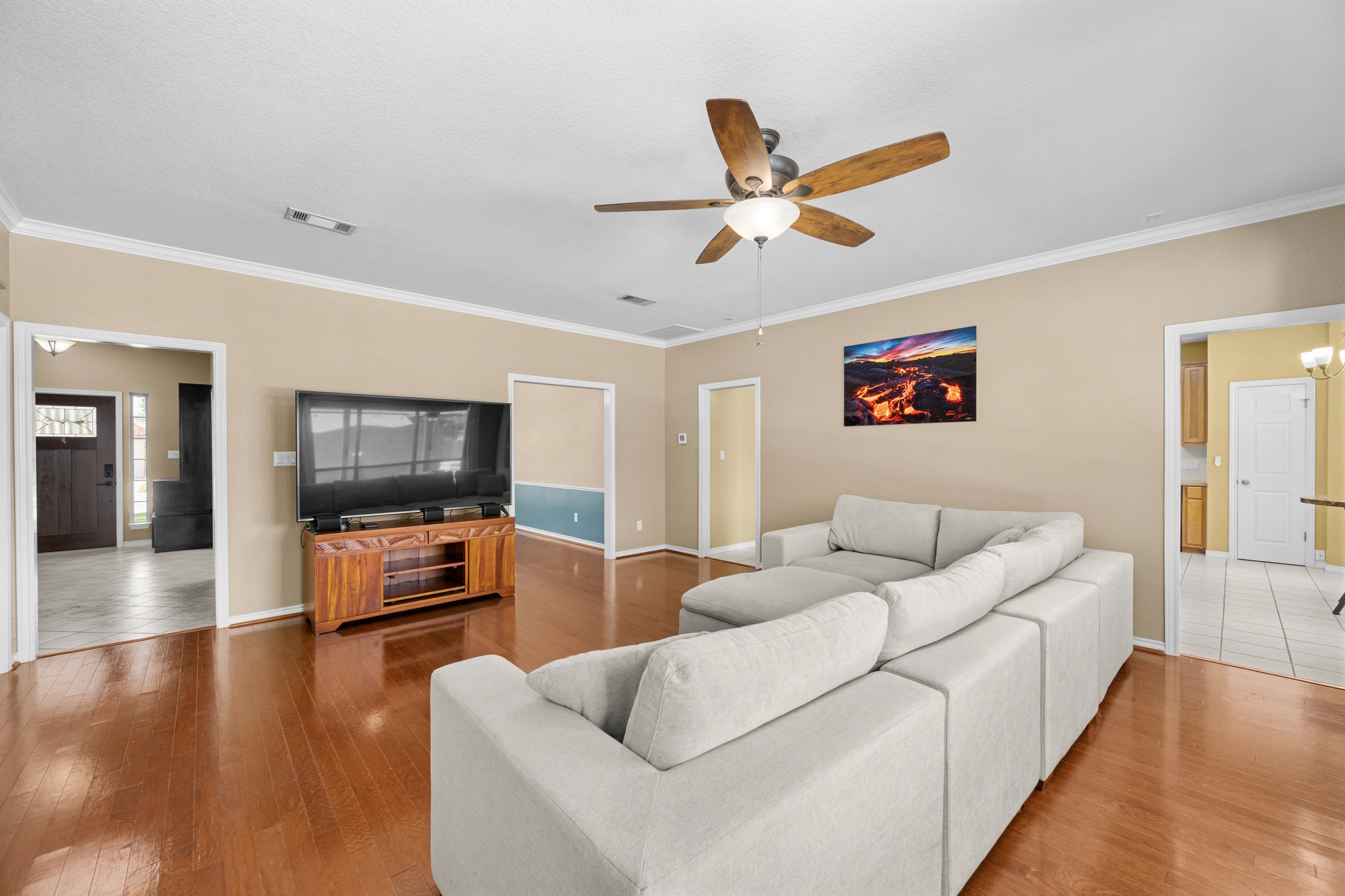 108 Thornwood Road Georgetown, TX 78628 - Photo 12 of 40 Hardwood floors and crown molding elevate this open-concept living area.