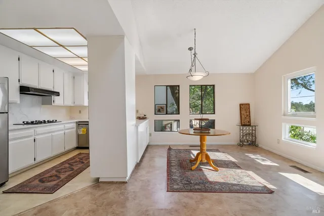 a kitchen with a refrigerator and a stove