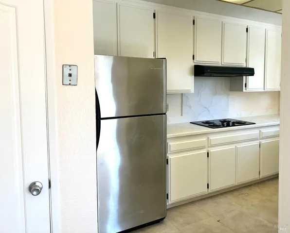 a kitchen with stainless steel appliances a sink cabinets and wooden floor