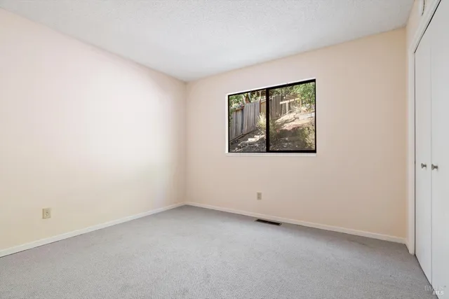 a spacious bedroom with a bed and a window
