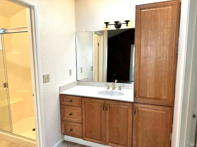 a view of a plants and trees with wooden fence