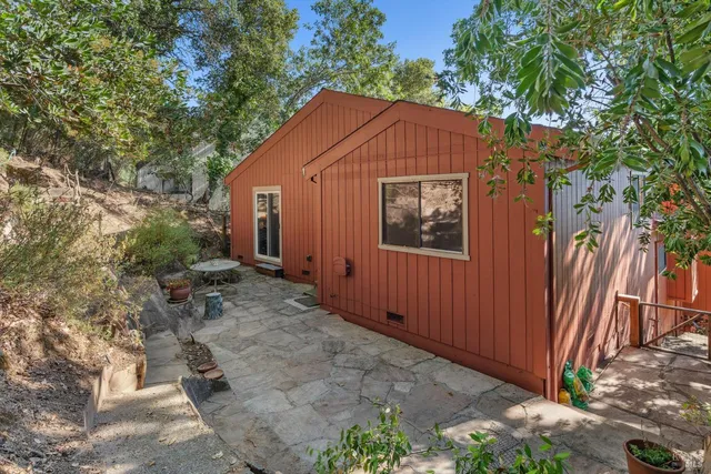 a view of backyard with wooden fence and plants