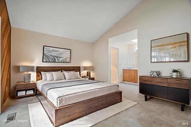 a bedroom with a bed and a couch