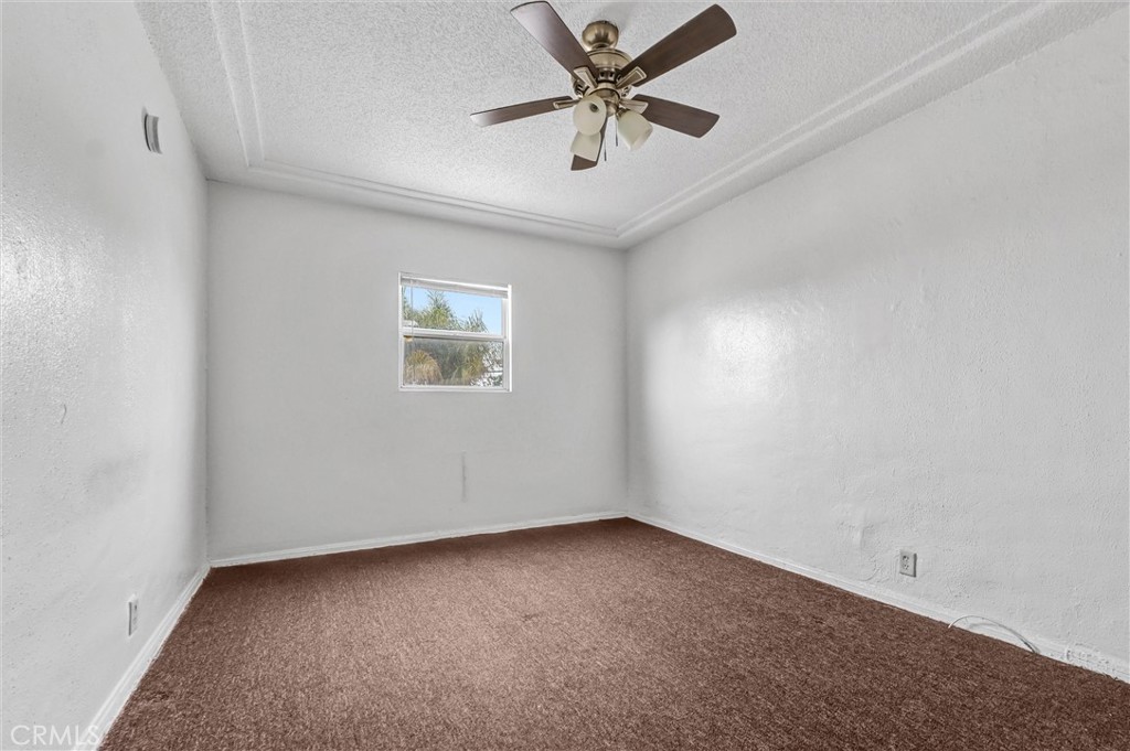 2112 South Burnside Avenue Los Angeles, CA 90016 - Photo 17 of 26 an empty room with a window and a fan