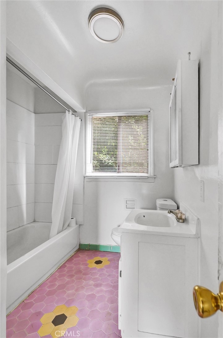 2112 South Burnside Avenue Los Angeles, CA 90016 - Photo 19 of 26 a bathroom with a sink and a mirror