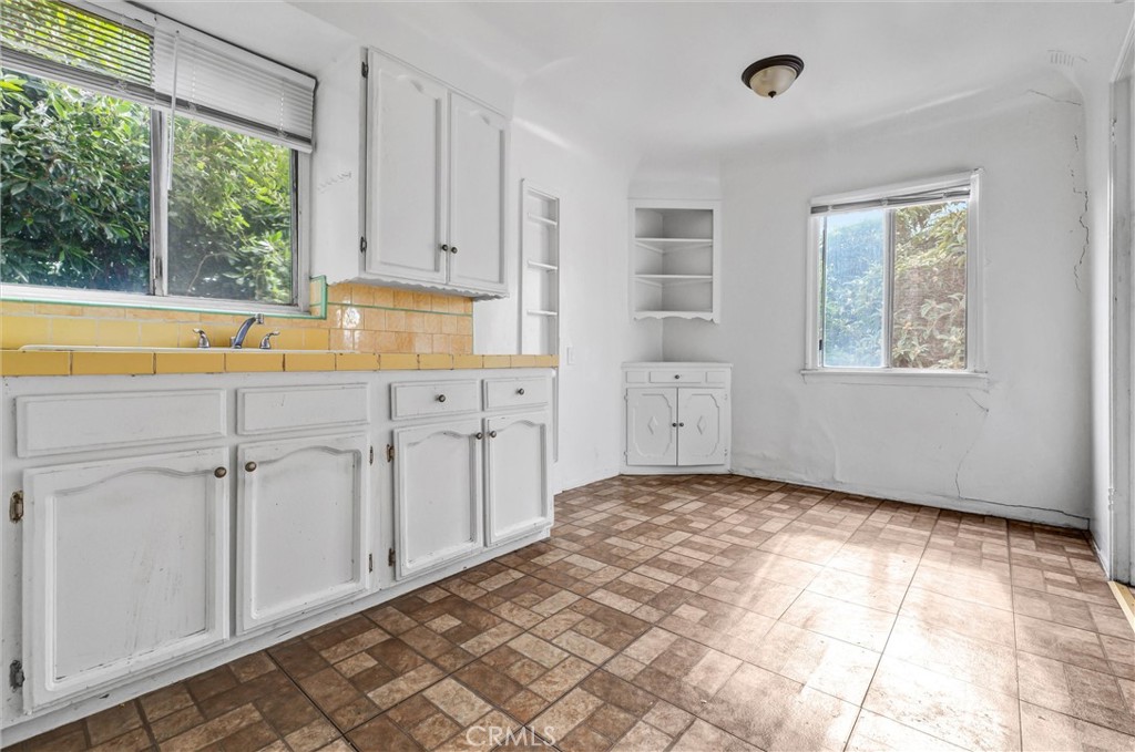 2112 South Burnside Avenue Los Angeles, CA 90016 - Photo 21 of 26 a view of a kitchen with white cabinets and a window