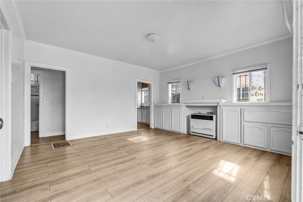 2112 South Burnside Avenue Los Angeles, CA 90016 - Photo 3 of 26 a view of a kitchen with wooden floor and electronic appliances