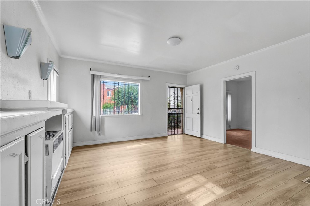 2112 South Burnside Avenue Los Angeles, CA 90016 - Photo 4 of 26 a view of a kitchen and an empty room with a kitchen