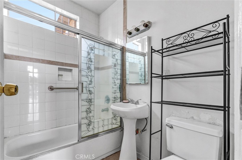 2112 South Burnside Avenue Los Angeles, CA 90016 - Photo 6 of 26 a bathroom with a shower and a sink