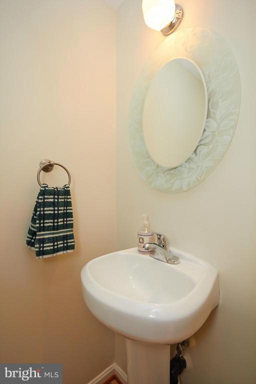 11008 Saffold Way Reston, VA 20190 - Photo 14 of 24 a bathroom with a sink a mirror and a lamp
