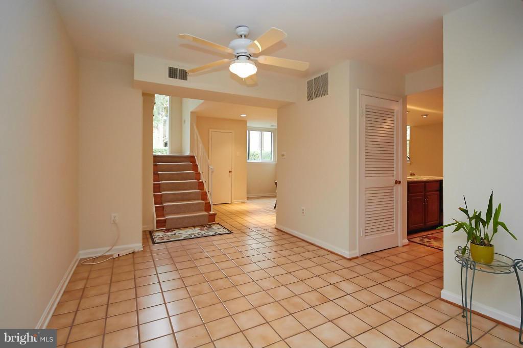 11008 Saffold Way Reston, VA 20190 - Photo 3 of 24 an empty room with wooden floor and windows