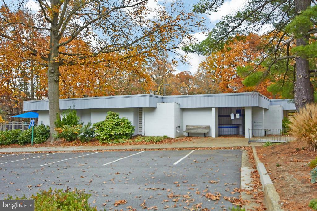 11008 Saffold Way Reston, VA 20190 - Photo 22 of 24 a front view of a house with a yard and a garage