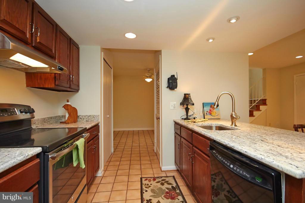 11008 Saffold Way Reston, VA 20190 - Photo 9 of 24 a kitchen with a sink and a stove top oven