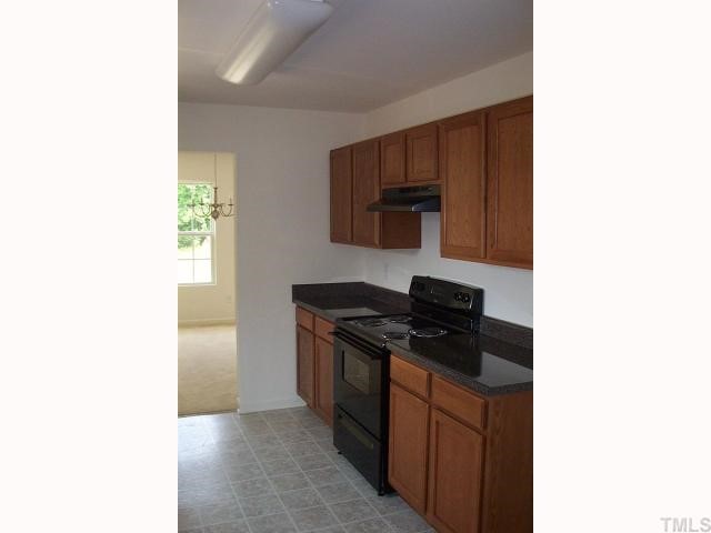 2711 Brownlow Court Raleigh, NC 27610 - Photo 5 of 11 a kitchen with a stove and a microwave