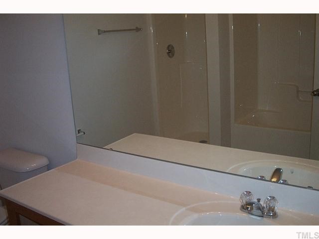 2711 Brownlow Court Raleigh, NC 27610 - Photo 6 of 11 a bathroom with a sink and a mirror