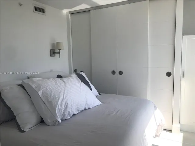 a living room with a bed furniture and a window