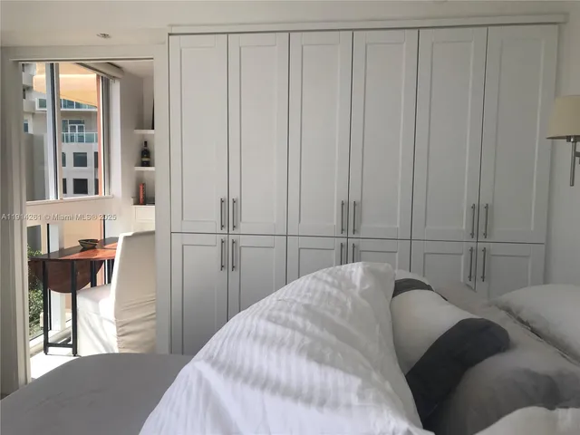 a view of a floor to ceiling window and a kitchen view