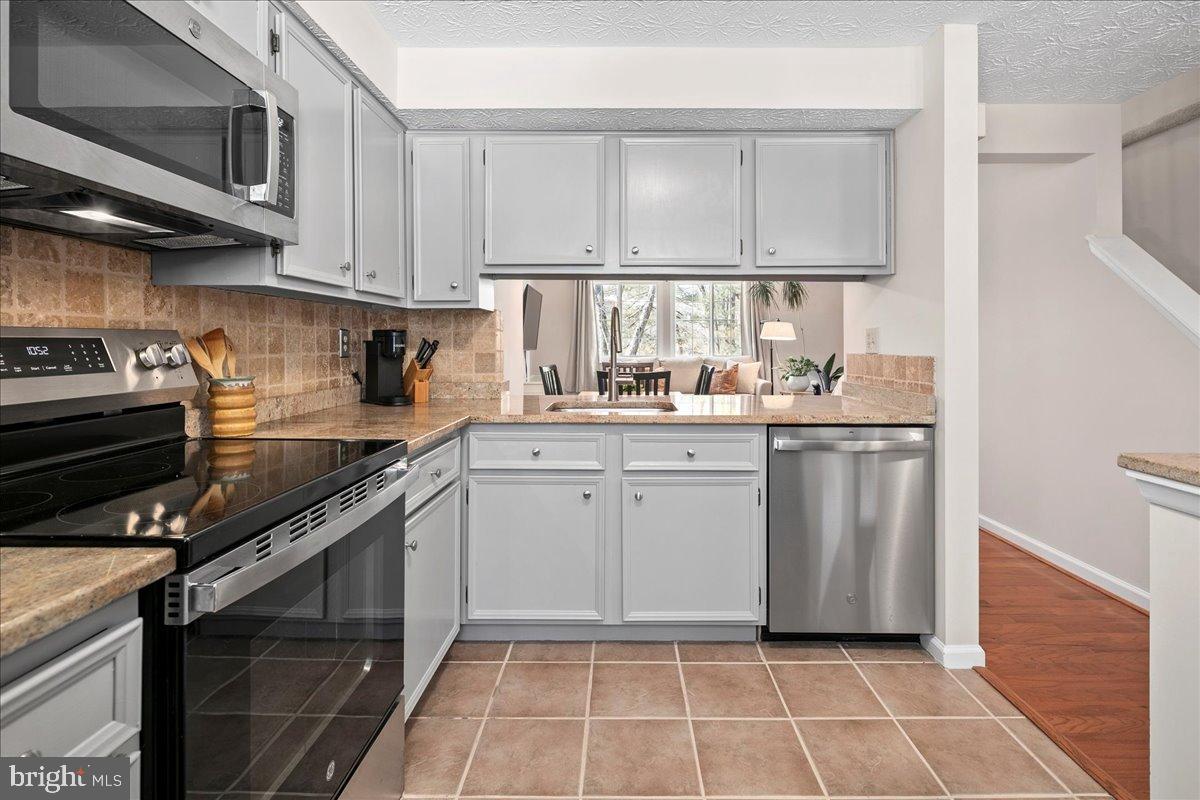 1642 Harvest Green Court Reston, VA 20194 - Photo 13 of 46 a kitchen with a sink appliances cabinets and a window