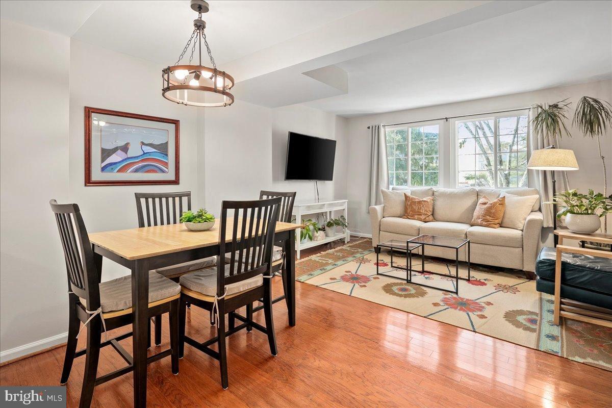 1642 Harvest Green Court Reston, VA 20194 - Photo 14 of 46 a living room with furniture dining table and a flat screen tv