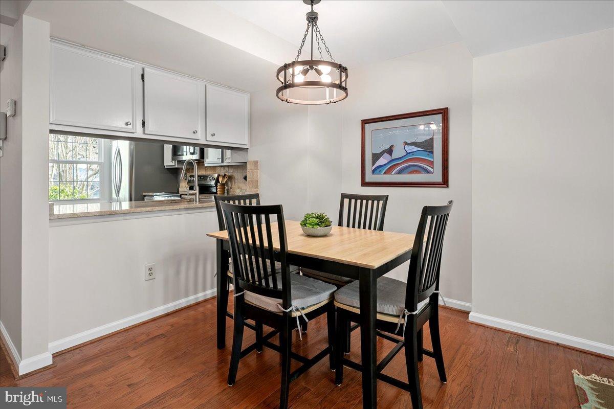 1642 Harvest Green Court Reston, VA 20194 - Photo 15 of 46 a view of a dining room with furniture wooden floor and chandelier