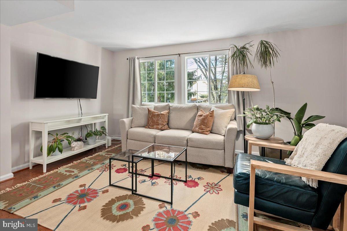 1642 Harvest Green Court Reston, VA 20194 - Photo 18 of 46 a living room with furniture a flat screen tv and a fireplace